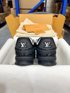 Louis Vuitton low-top sneakers back view, dark heels with large white LV monograms