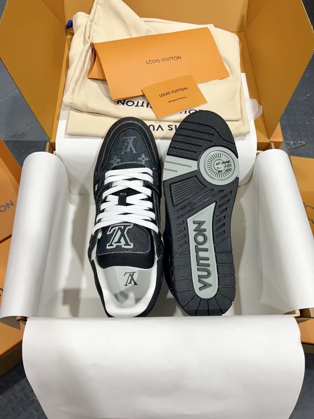 Louis Vuitton low-top sneakers with white laces, showing toe prints and treaded outsole