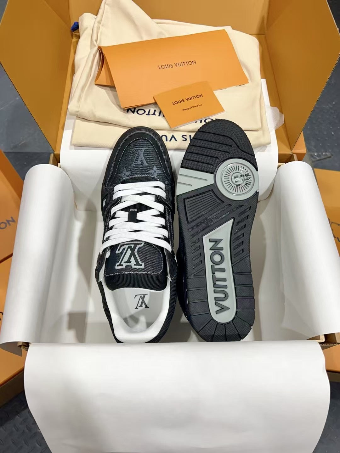 Louis Vuitton low-top sneakers with white laces, showing toe prints and treaded outsole