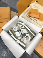 Louis Vuitton trainer shoes, side-by-side top view, white uppers with olive monogram pattern