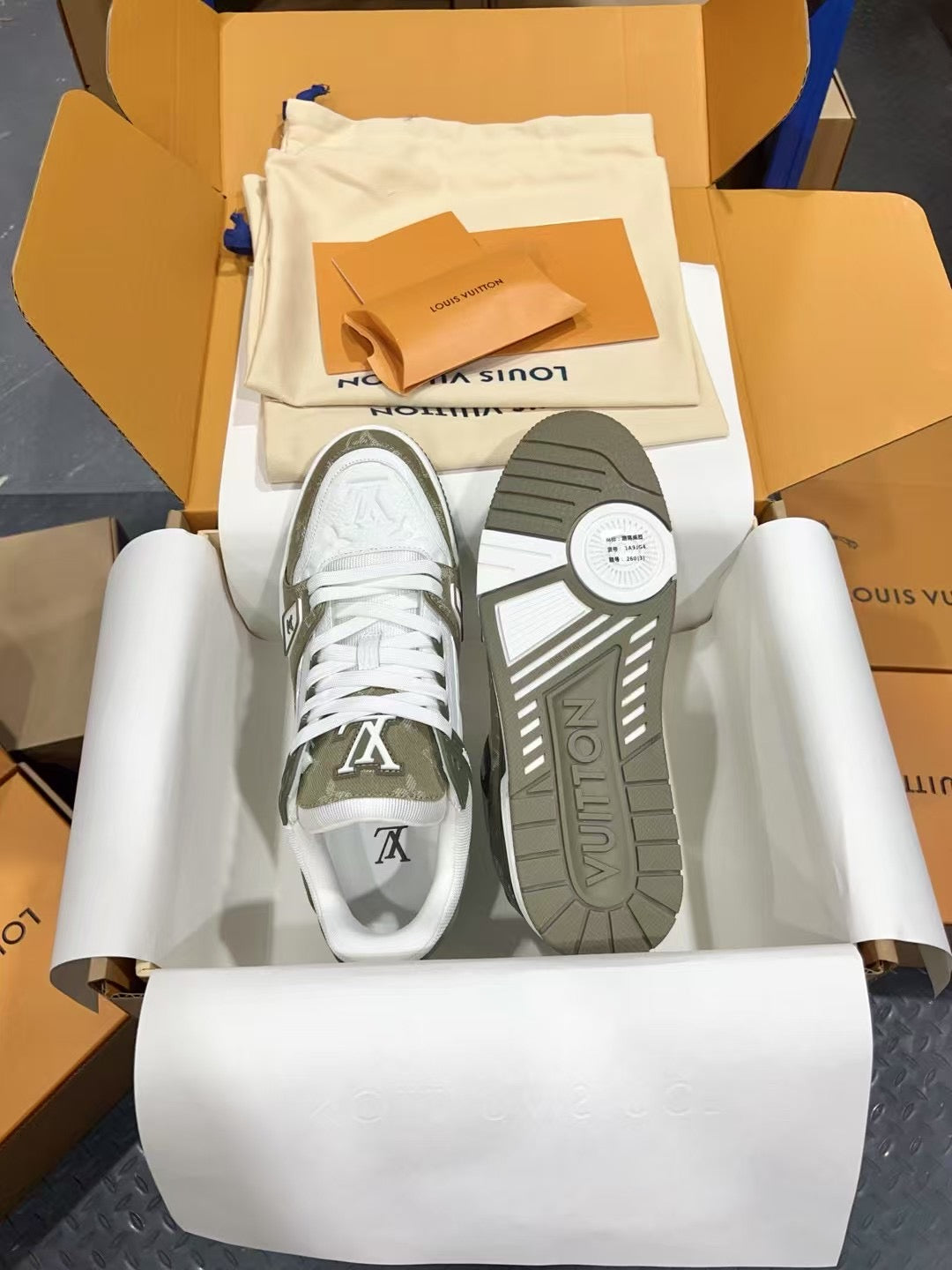 Louis Vuitton trainer shoes, sole view, white uppers with olive monogram trim and laces