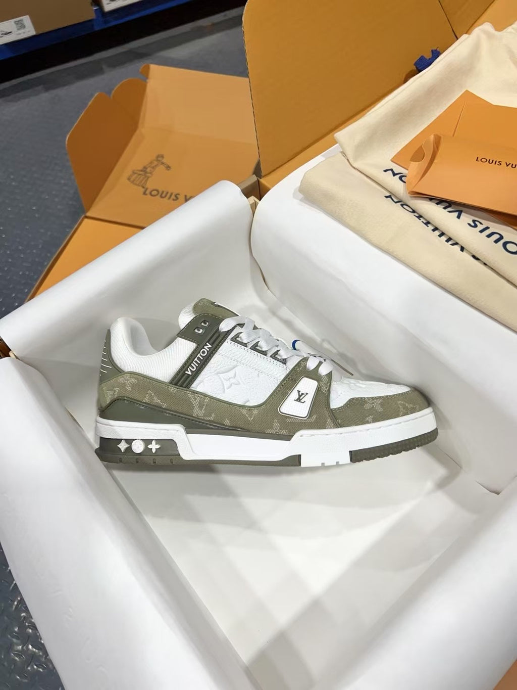 Louis Vuitton trainer shoe, side view, white and olive monogram panel, white lace-up