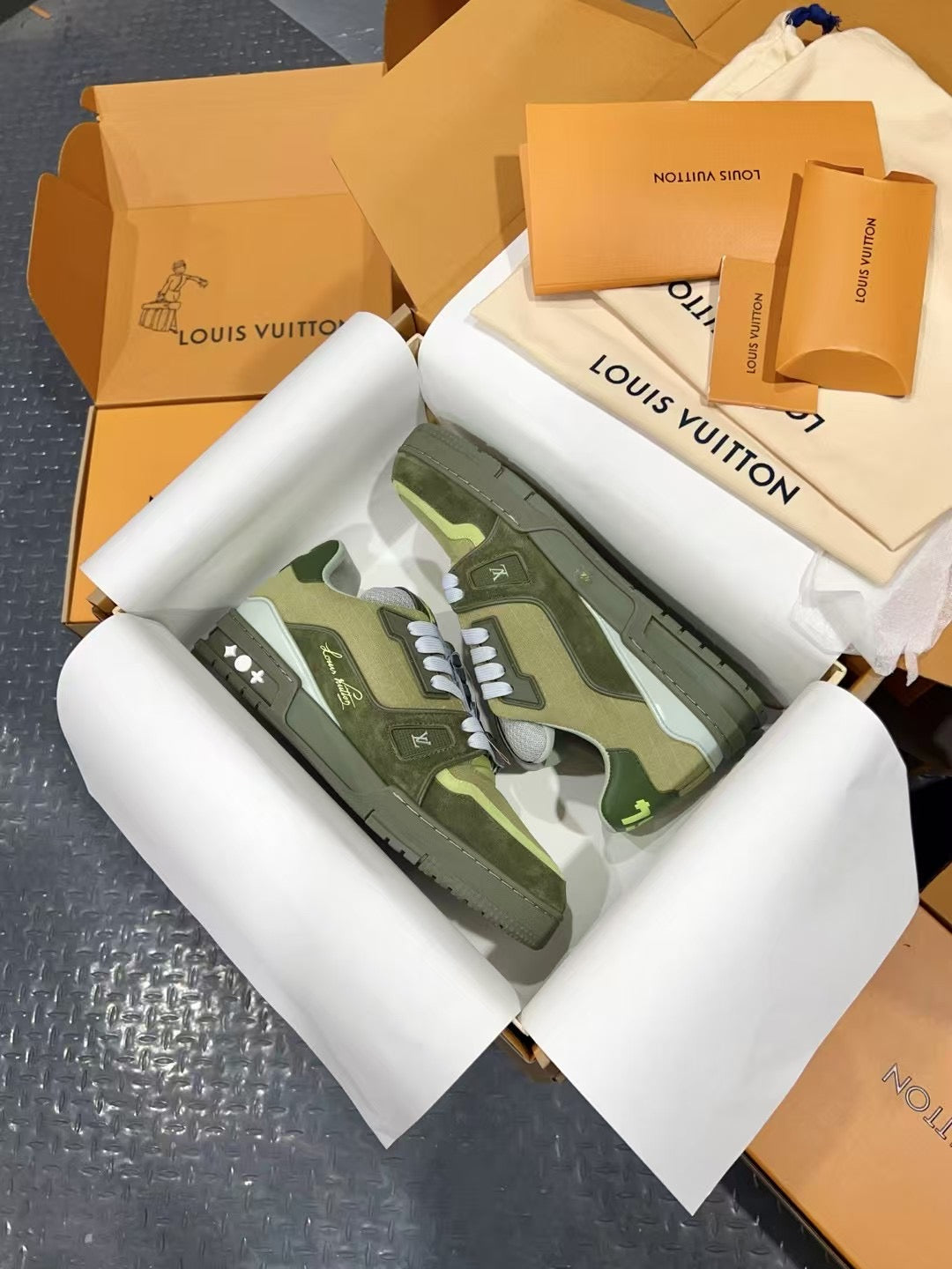 Louis Vuitton trainer sneakers with camo-style green uppers and white laces