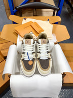 Louis Vuitton trainer sneakers in dark gray and white, front view with lace-up design