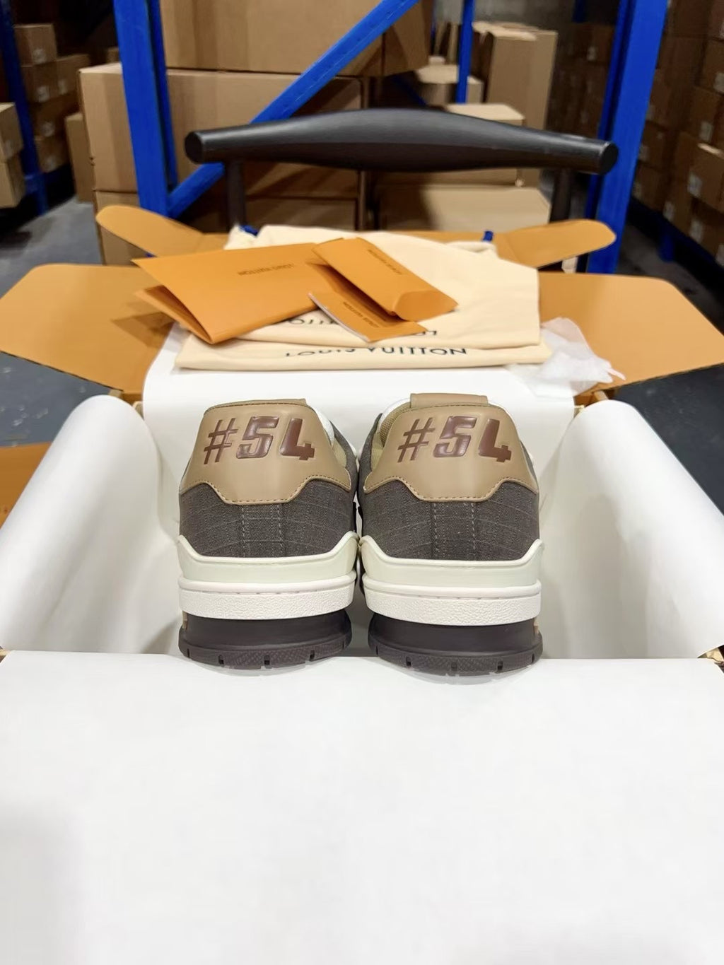 Louis Vuitton trainer sneakers with dark gray heels and white midsoles, back view
