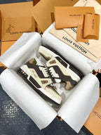 Louis Vuitton trainer sneakers with dark gray camouflage-style uppers and white laces