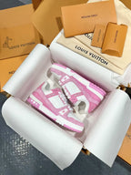 Pink and white low-top sneakers showing front and side logo panels