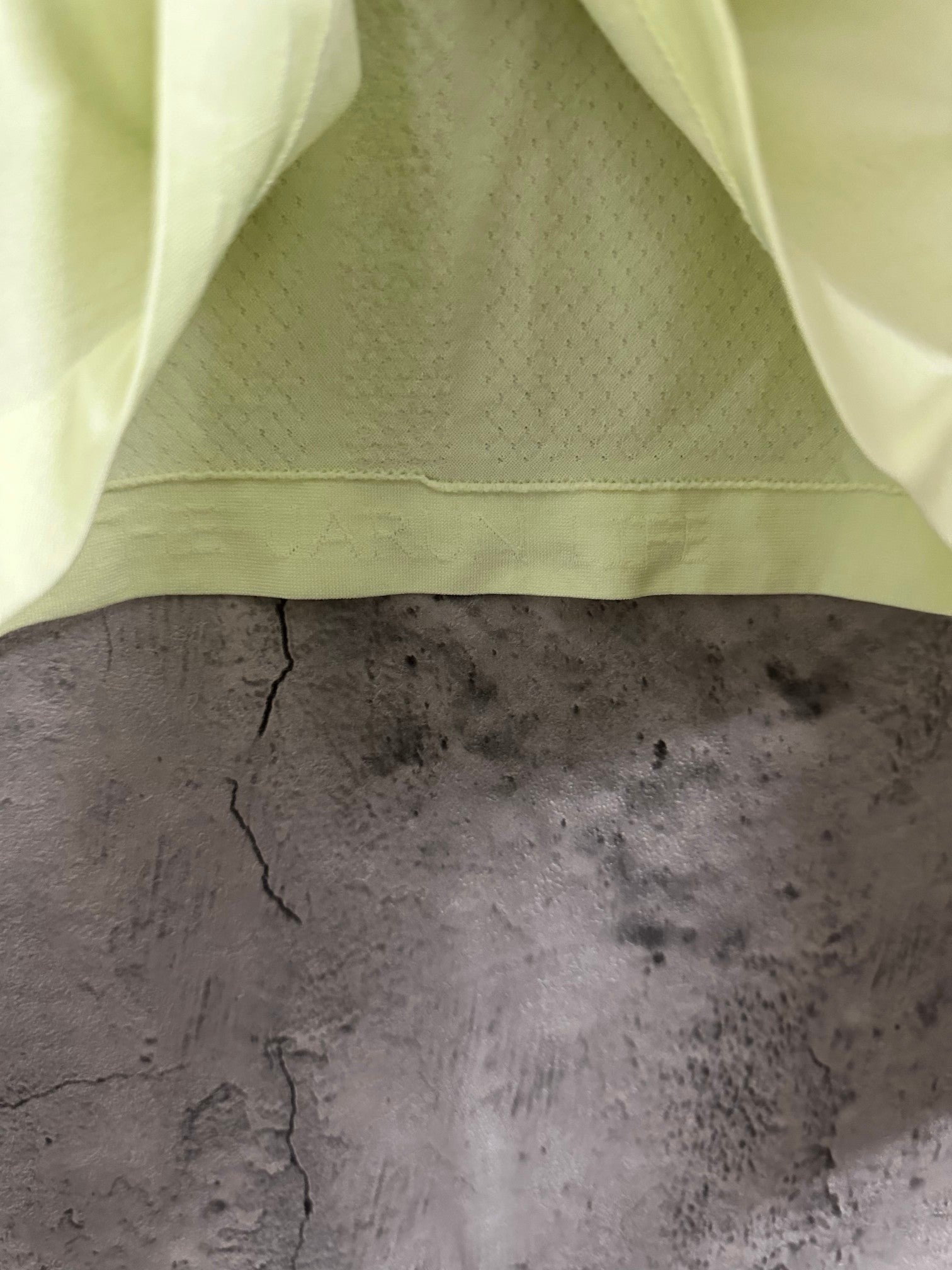 Light lime long-sleeve shirt interior hem with knit texture