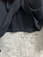 Black long-sleeve top with relaxed fit and gathered hem