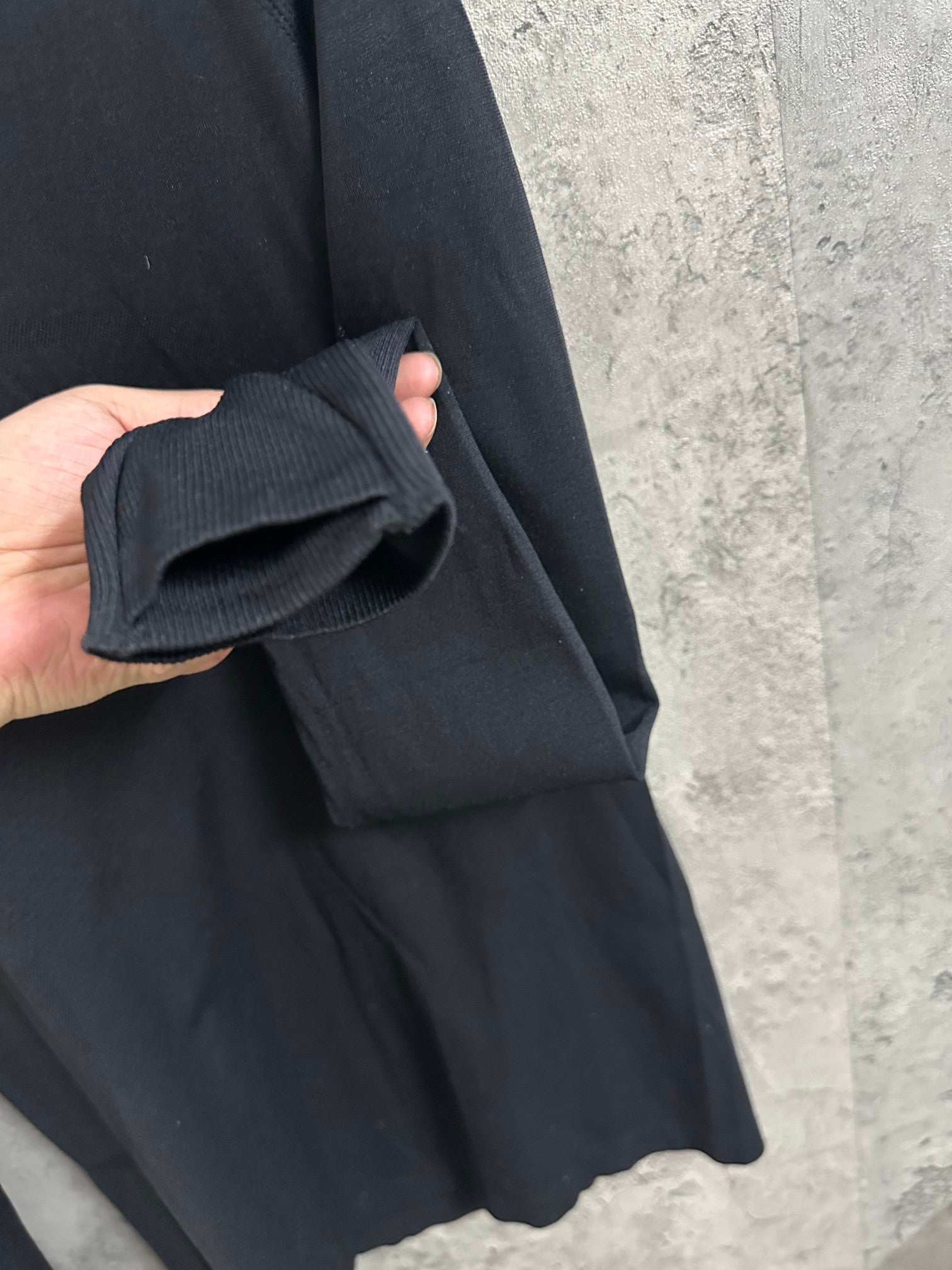 Black long-sleeve top sleeve cuff detail with ribbed knit edge