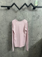 Pink long-sleeve crewneck T-shirt, back view on hanger
