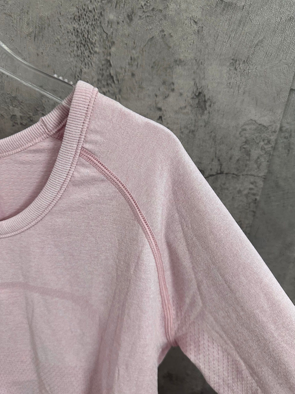 Light pink long-sleeve top with contrast-stitched collar and shoulder