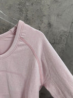 Light pink long-sleeve top with contrast-stitched collar and shoulder