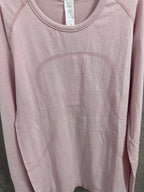 Pink long-sleeve crewneck T-shirt front, partial close-up