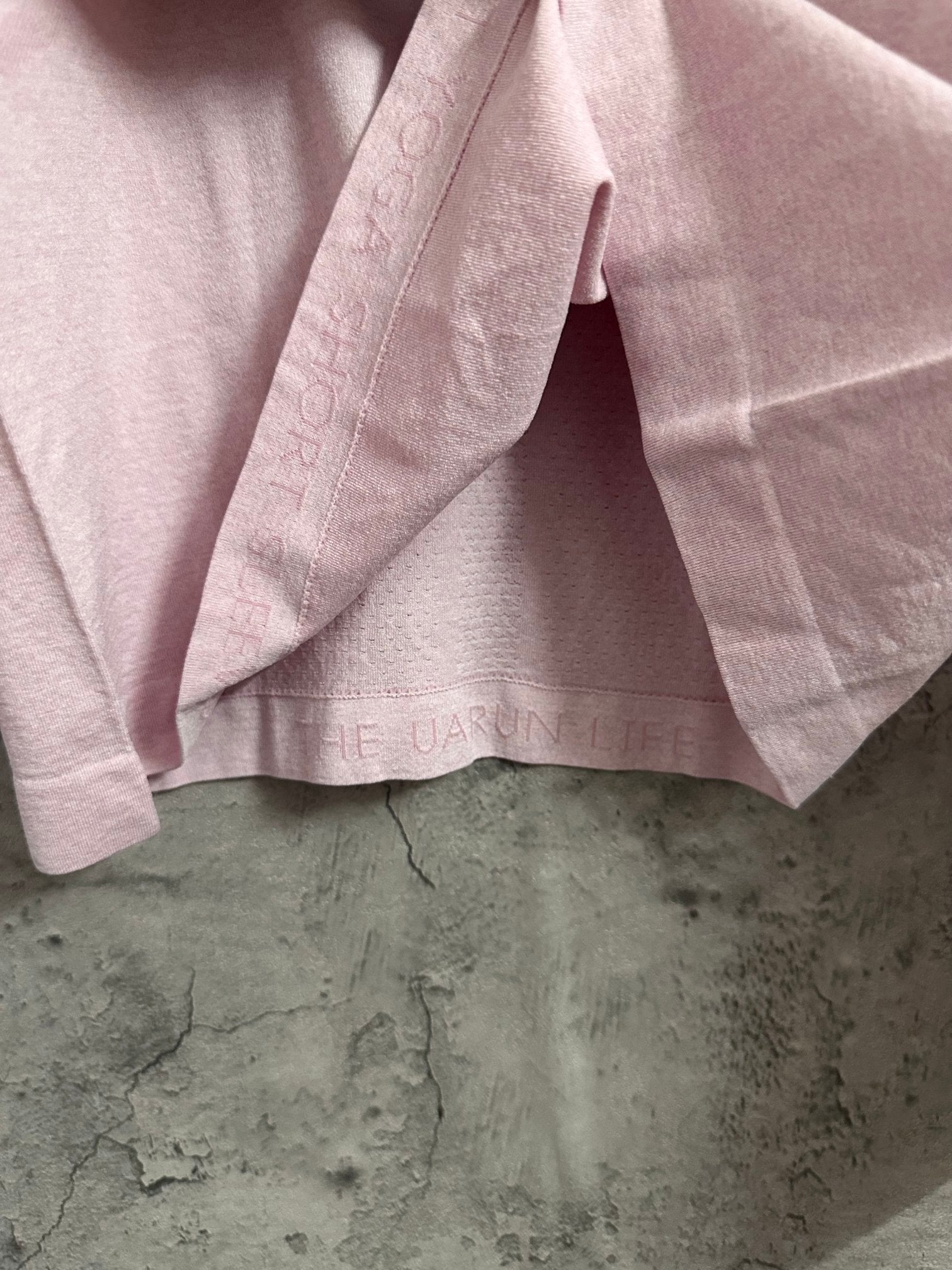 Pink long-sleeve T-shirt hem and side seam detail
