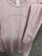 Light pink long-sleeve top with sleeve cuff and rounded neckline