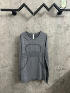 Heather gray long-sleeve knit top with crew neck and abstract horse graphic print