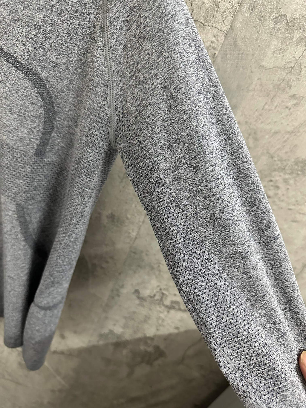 Heather gray long-sleeve knit top sleeve detail, textured knit surface