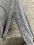 Heather gray long-sleeve knit top sleeve detail, textured knit surface