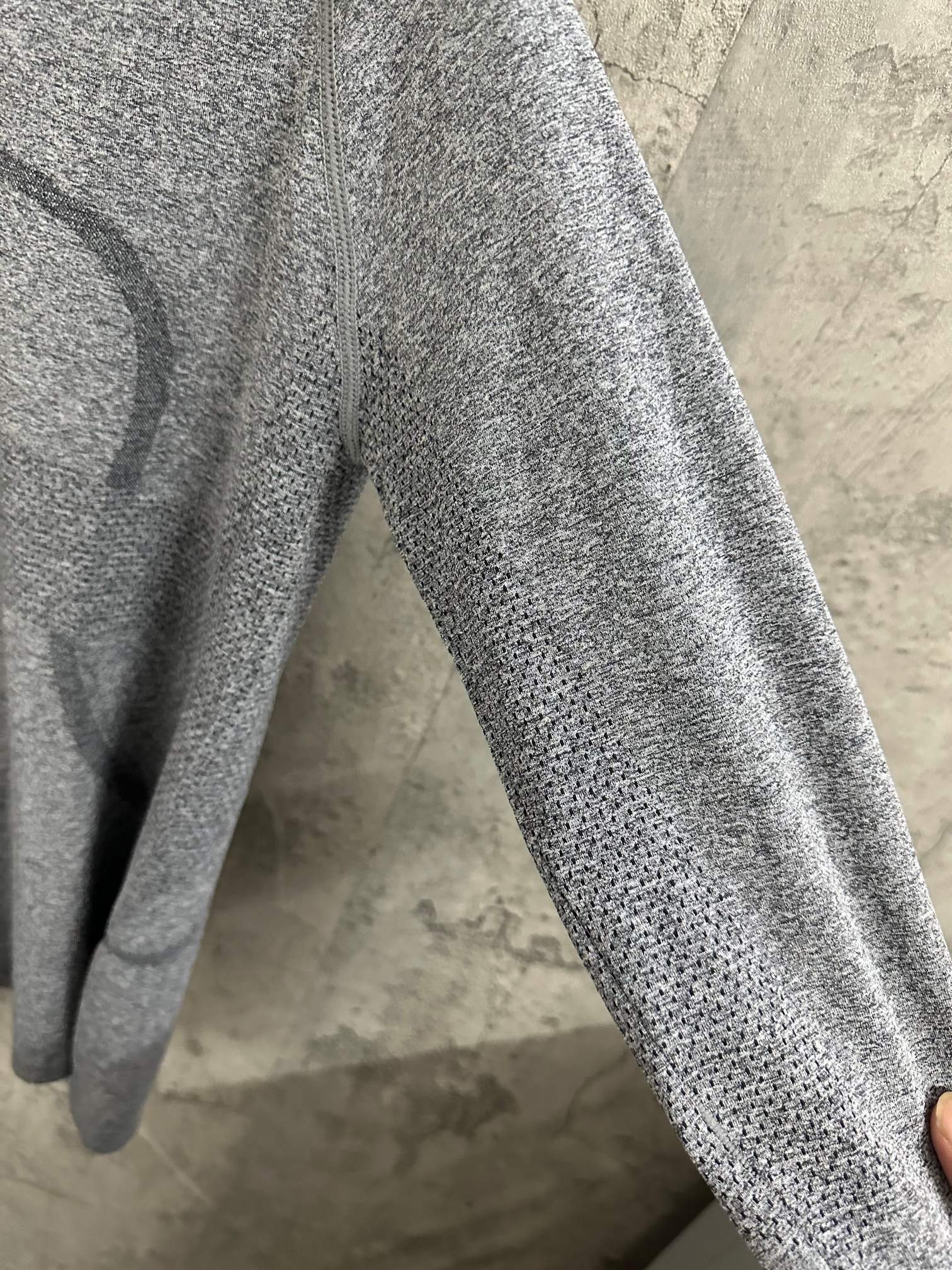 Heather gray long-sleeve knit top sleeve detail, textured knit surface