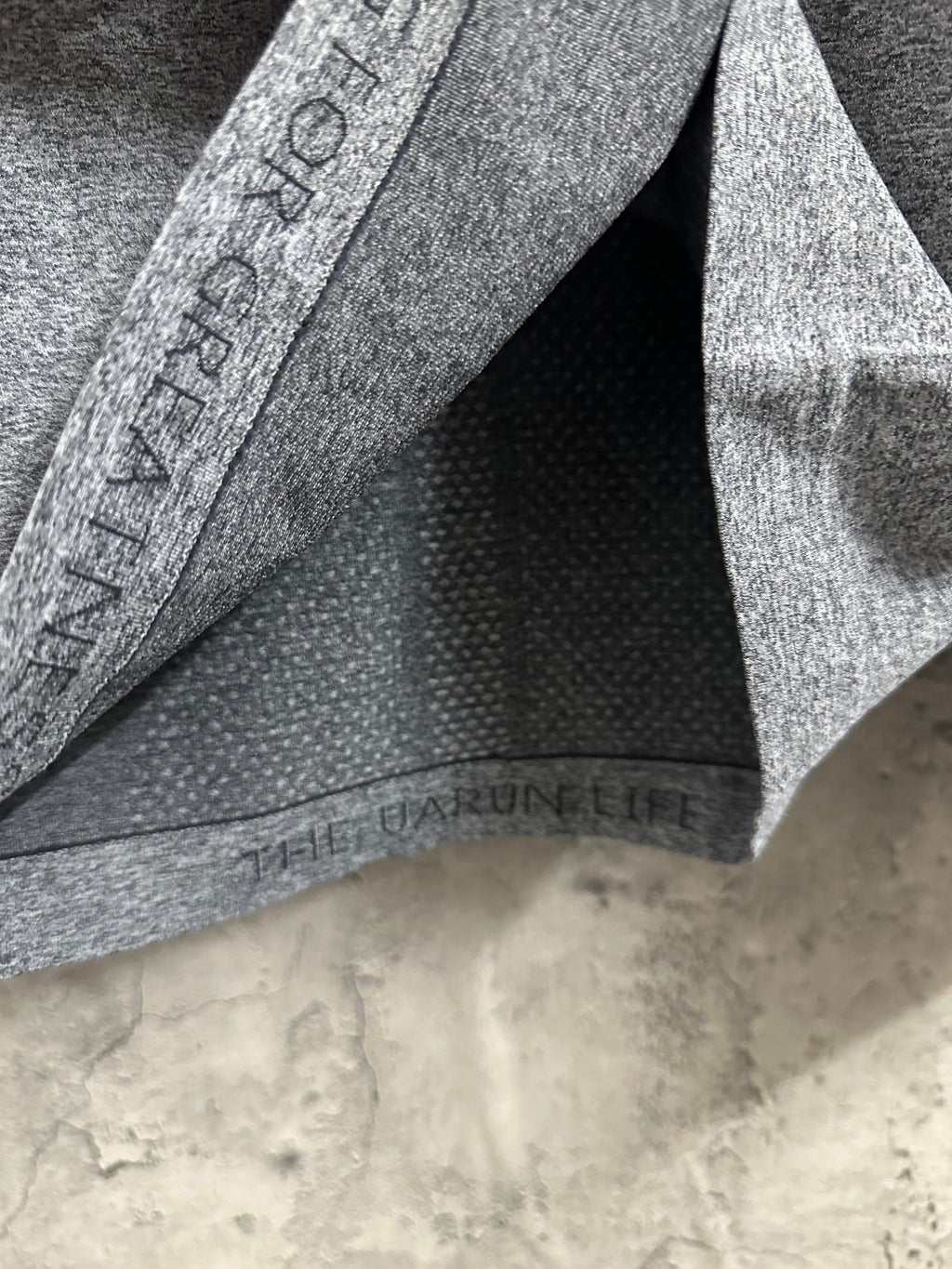 Heather gray knit top inside hem with printed label band