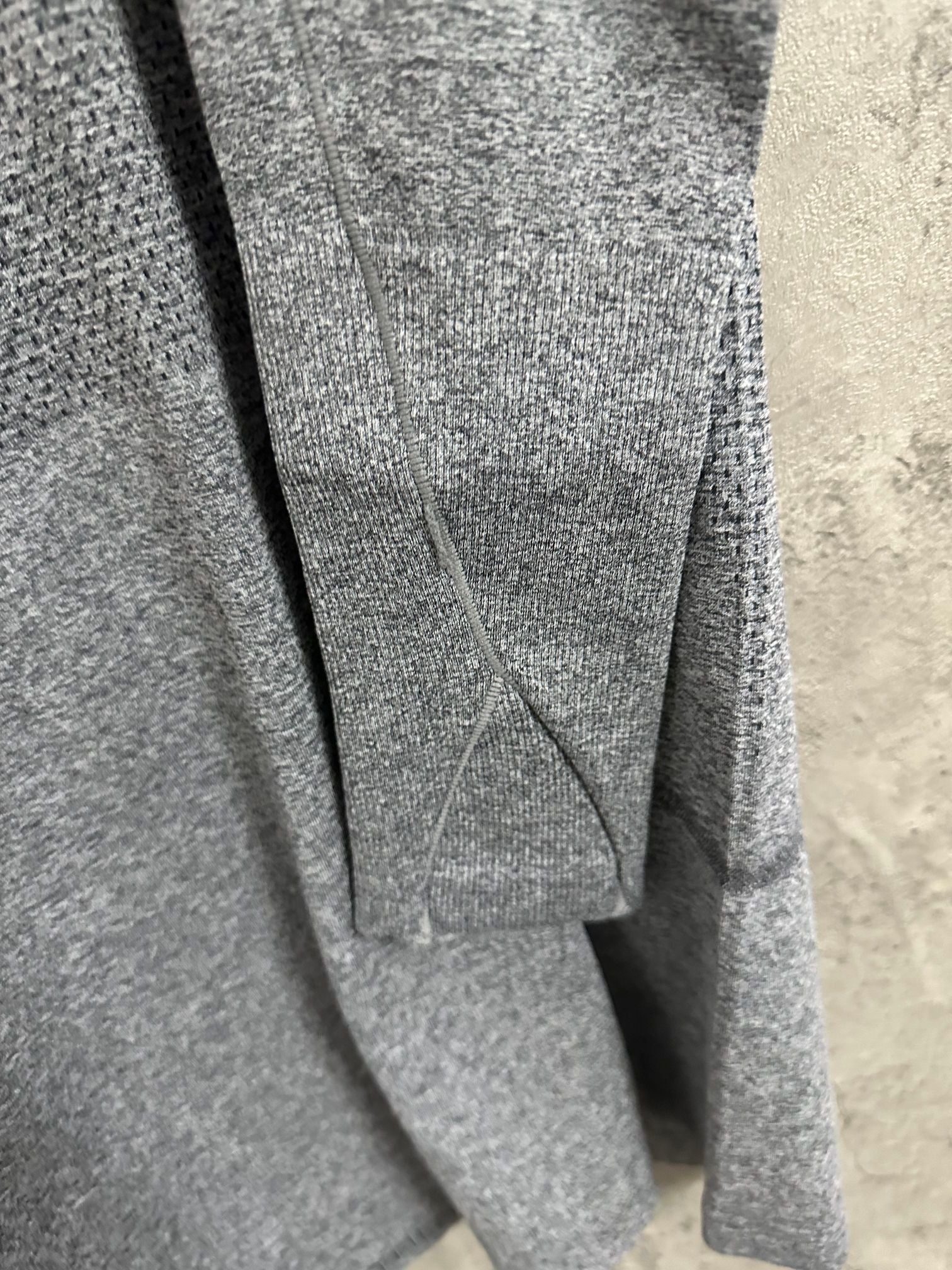 Heather gray long-sleeve knit top close-up of back seam and neckline area