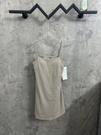 Light beige spaghetti-strap romper with scoop neckline and attached tags