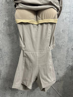 Light beige romper with ruched waist detail and short covered legs