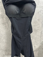 Black dress close-up of bust and waistband with gathered skirt section.