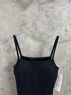 Black spaghetti-strap dress viewed from back with straight shoulder straps on hanger.