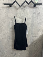Black spaghetti-strap dress with fitted bodice and straight skirt hem on hanger.