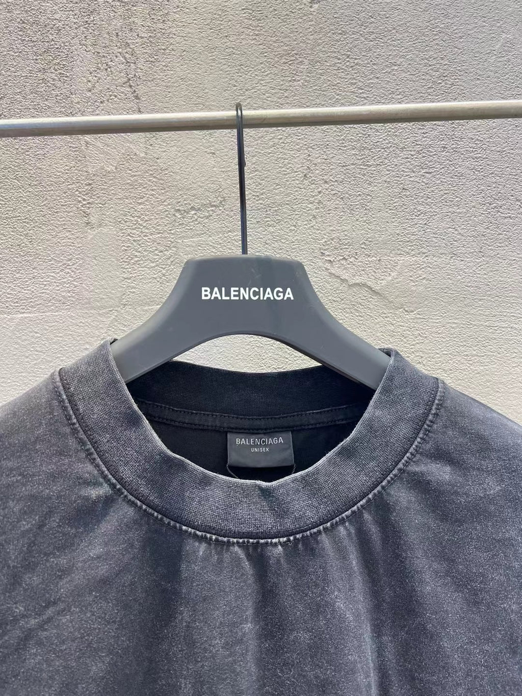 Charcoal T-shirt neckline close-up with Balenciaga label at the collar