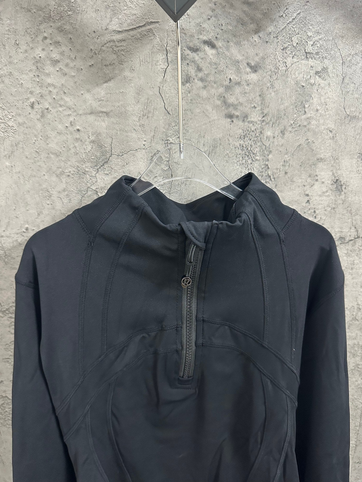 Ralph Lauren hooded outerwear in dark color, front quarter-zip and ribbed drawcord hood