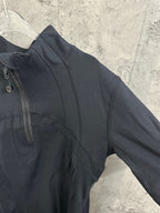 Dark long-sleeve jacket sleeve with side seam and curved chest panel