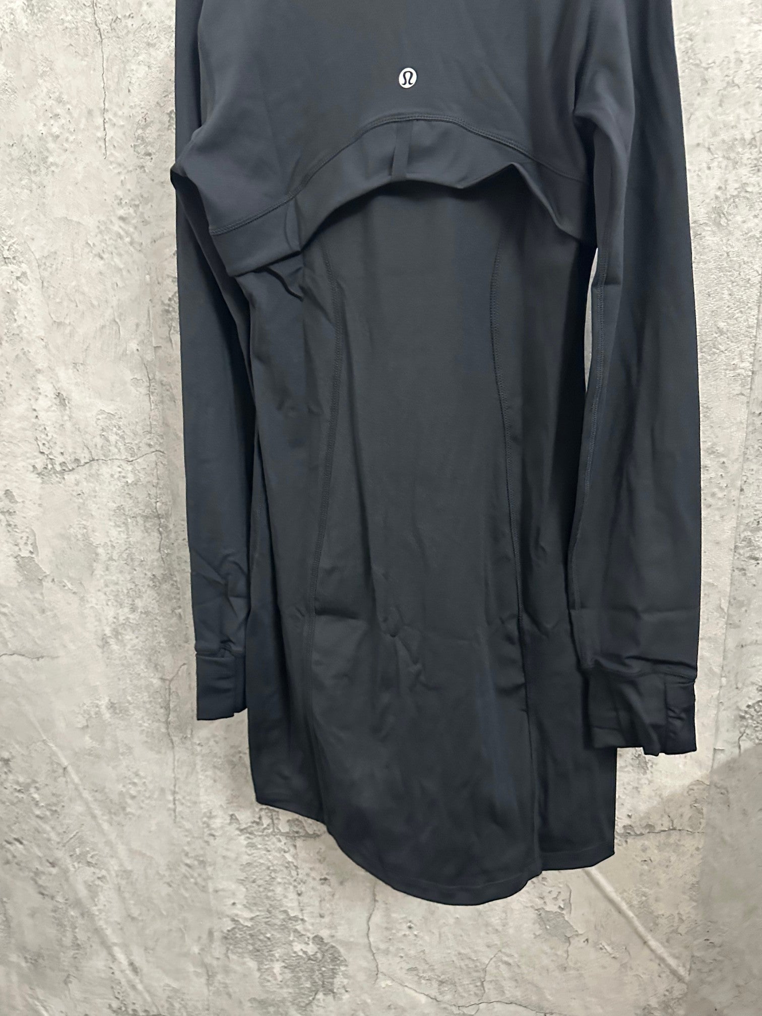Dark long-sleeve jacket back view with small chest logo