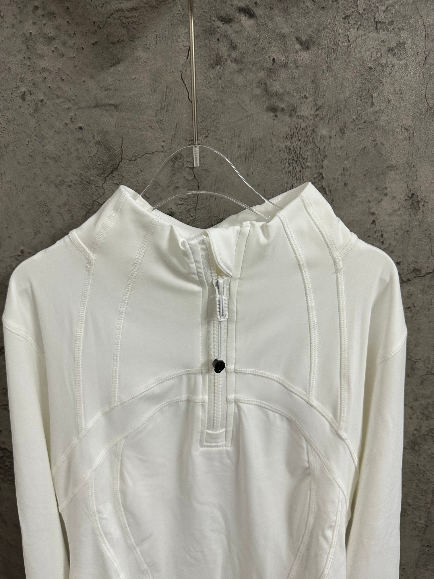 White shirt dress neckline detail with central placket and small button