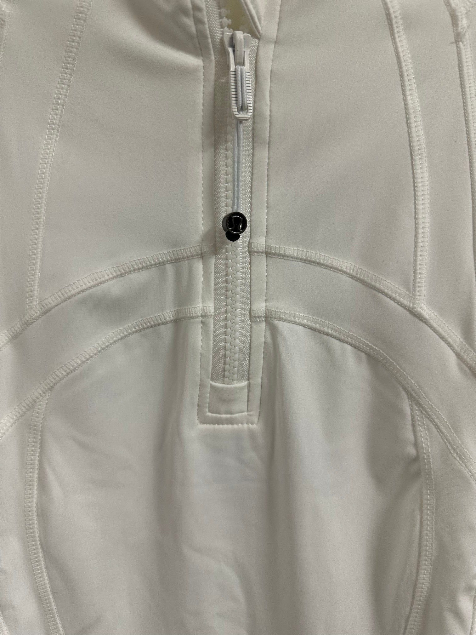 White shirt dress placket and curved panel seam with metal zipper pull