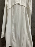 White shirt dress back view with vertical seams and curved yoke panel
