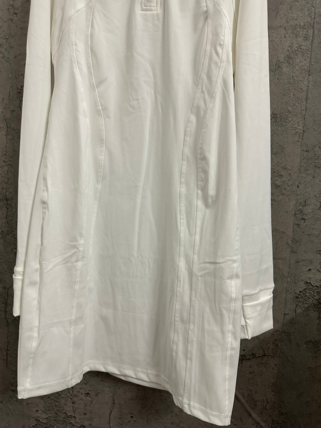 White shirt dress with long sleeves and straight hem with side pocket