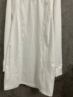 White shirt dress with long sleeves and straight hem with side pocket