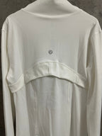 White shirt dress back view with curved yoke seam and small logo