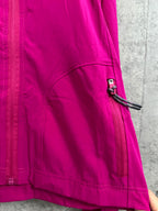 Fuchsia zip jacket with front pocket and curved seam detail