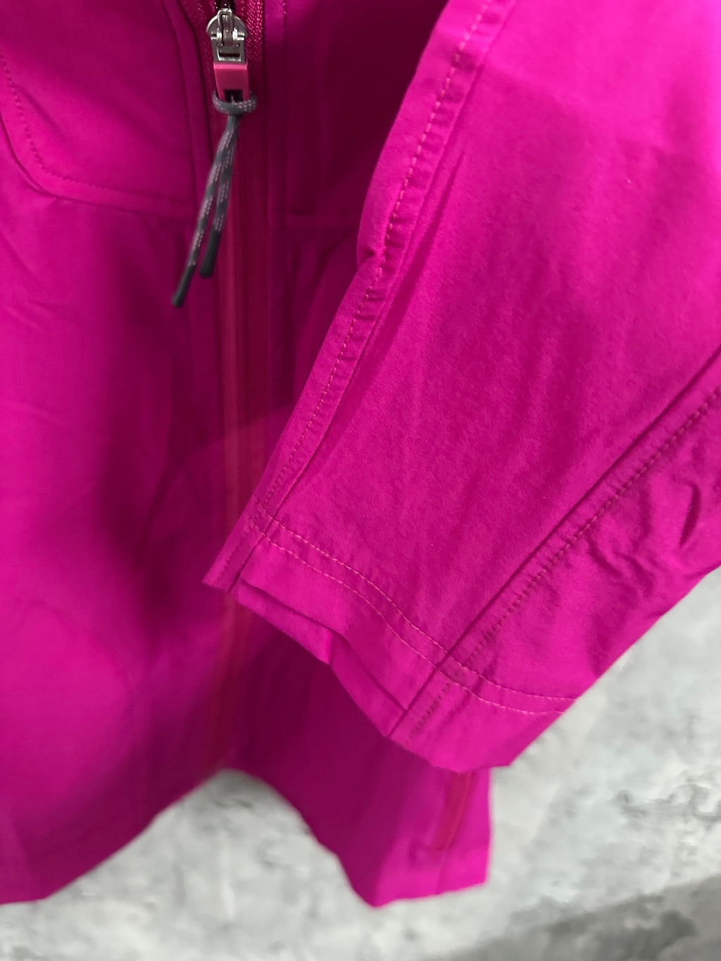 Fuchsia jacket with front zipper and side pocket, cropped view