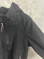 Black hooded jacket angled side view with zip pocket detail