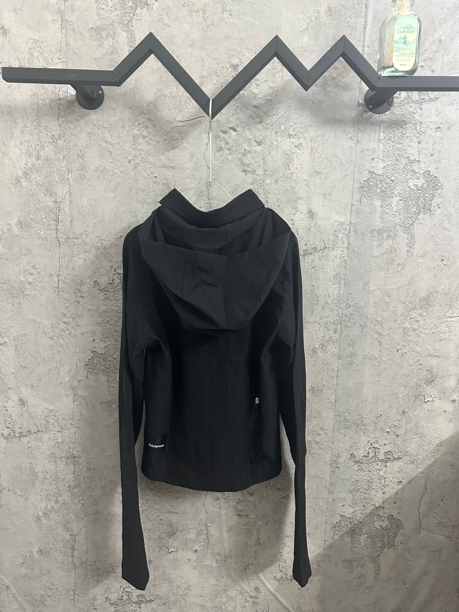 Black hooded jacket with zip front and kangaroo-style pockets