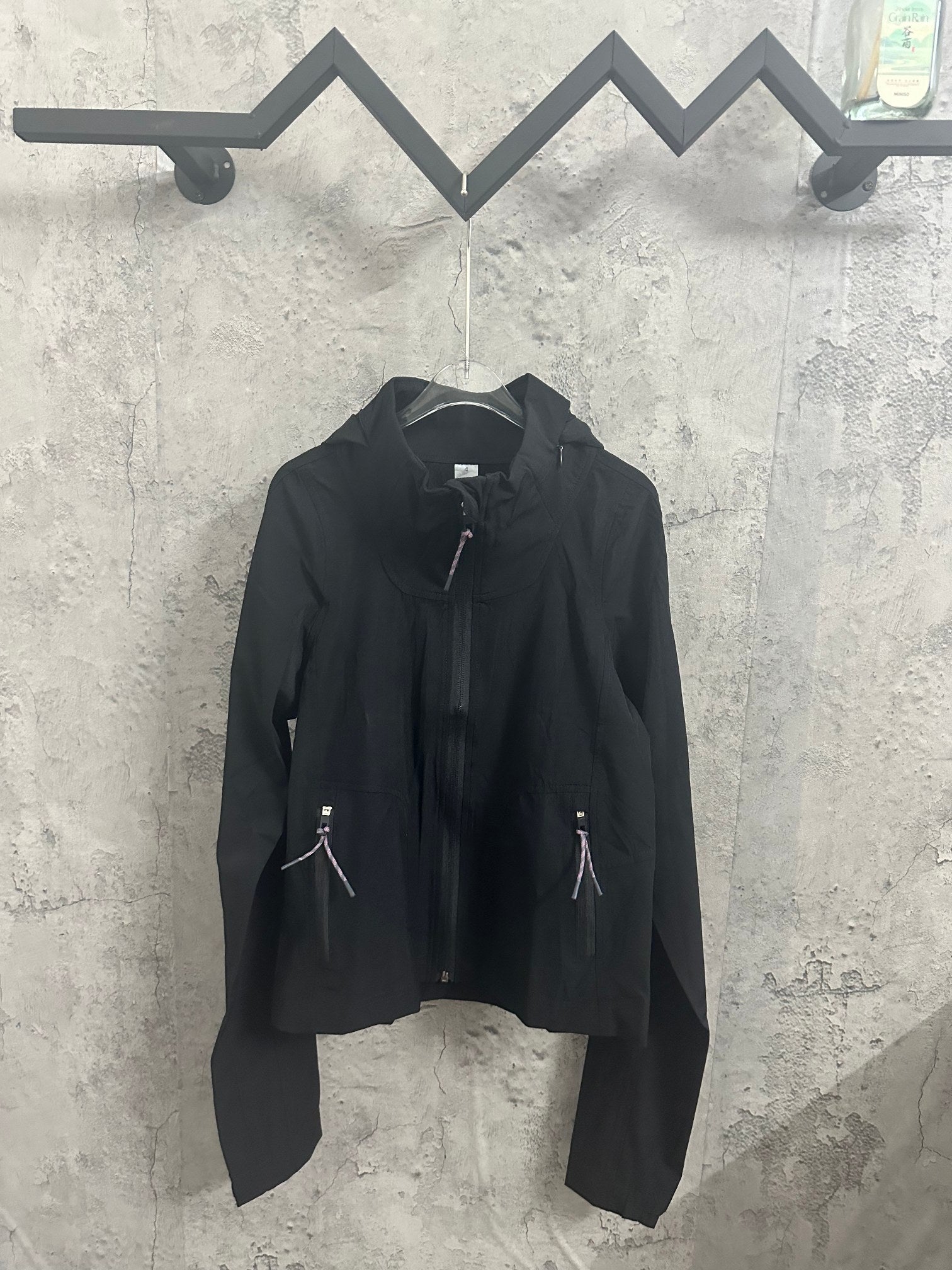Black hooded jacket with full front zipper and two side zip pockets
