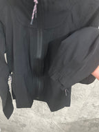 Black hooded jacket back view with zip pockets and hood drawstring cords