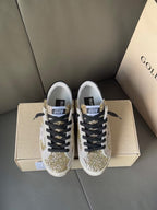 Golden Goose sneakers pair with gold glitter toe and side panels, black laces