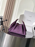 Purple Chanel mini shoulder bag with top handle and gold chain strap