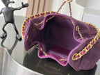 Open purple Chanel bag interior with gold chain shoulder strap